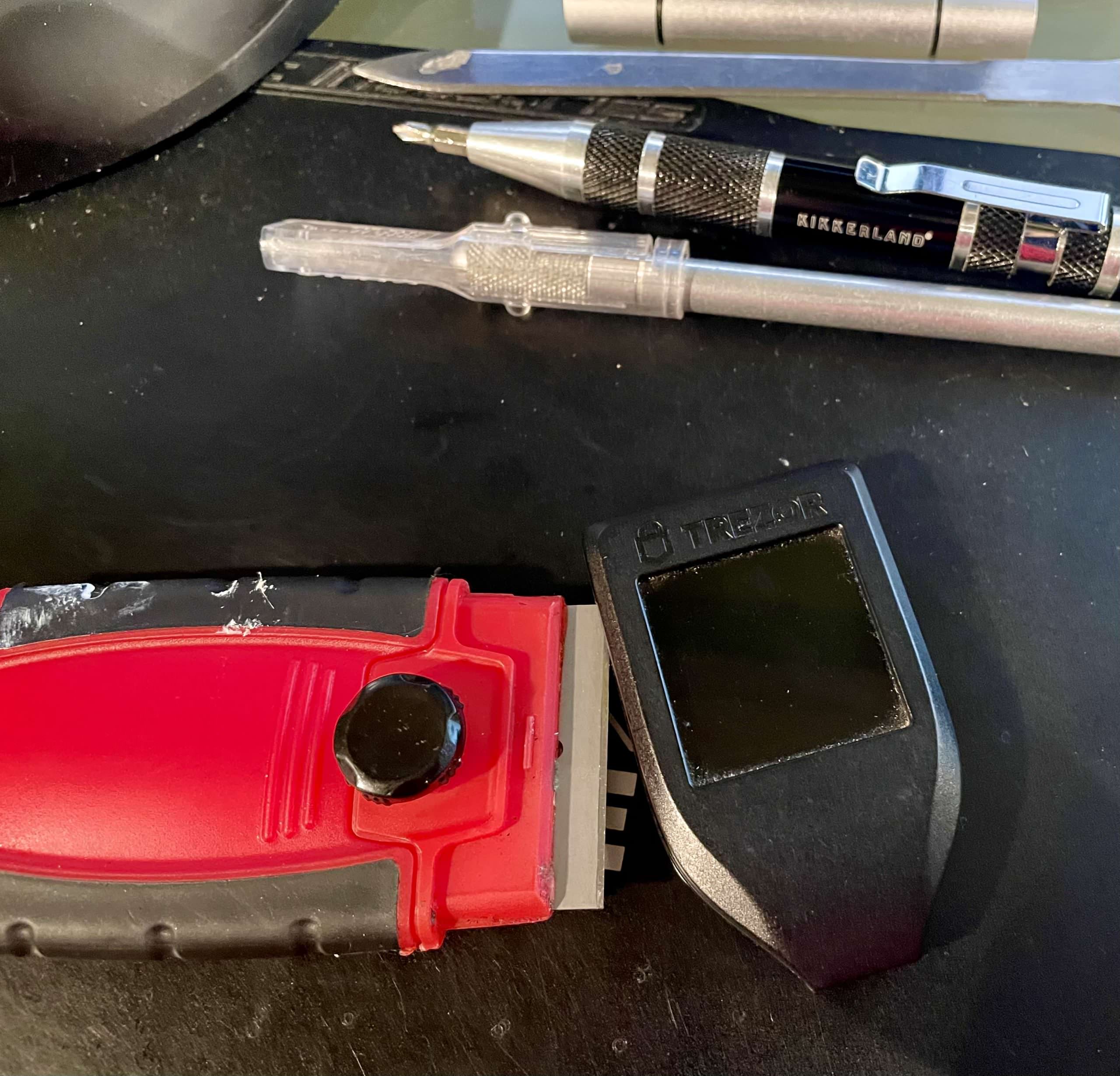 Trezor Model T case being cut open for touchscreen repair